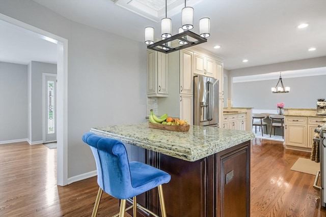4647 N Thatcher Ave, Norridge, IL 60706 - kitchen with stainless steel refrigerator with ice dispenser, a chandelier, dark wood-style floors, light stone counters, and baseboards