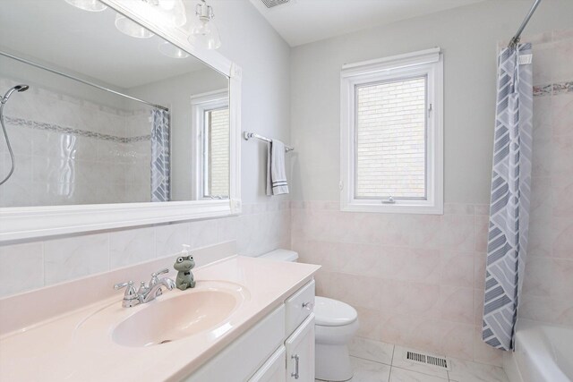 4647 N Thatcher Ave, Norridge, IL 60706 - bathroom with tile walls, vanity, toilet, tile patterned flooring, and shower / tub combo with curtain