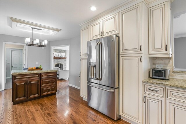 4647 N Thatcher Ave, Norridge, IL 60706 - kitchen with stainless steel fridge with ice dispenser, cream cabinetry, wood finished floors, and recessed lighting