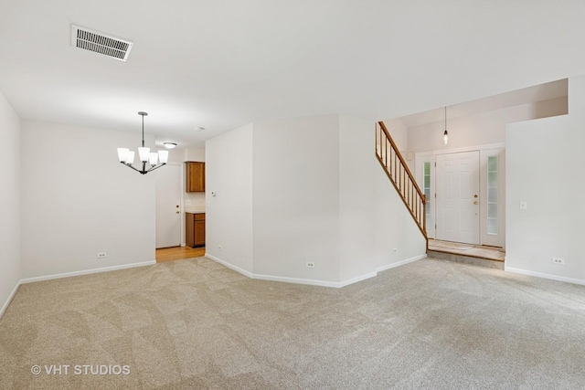 1087 Huntwyck Ct, Elgin, IL 60120 - empty room with a chandelier, stairs, and light colored carpet