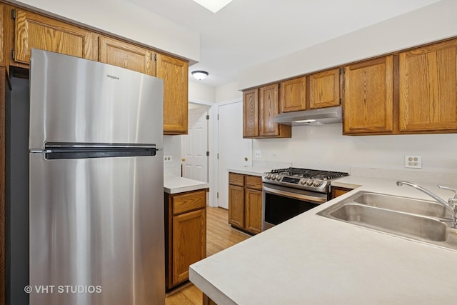 1087 Huntwyck Ct, Elgin, IL 60120 - kitchen with stainless steel appliances, under cabinet range hood, light wood finished floors, and brown cabinetry