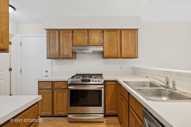 1087 Huntwyck Ct, Elgin, IL 60120 - kitchen with stainless steel appliances, under cabinet range hood, brown cabinets, and light countertops