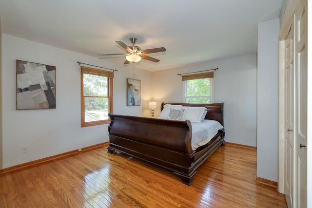 911 Woodland Hills Rd, Batavia, IL 60510 - bedroom featuring light wood-style floors, baseboards, and a ceiling fan