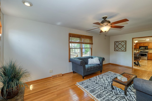 911 Woodland Hills Rd, Batavia, IL 60510 - living area with ceiling fan, baseboards, and light wood-style flooring