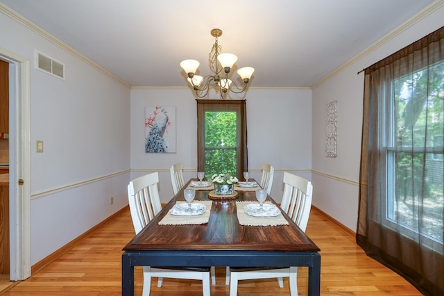 911 Woodland Hills Rd, Batavia, IL 60510 - dining area with a chandelier, light wood-style flooring, crown molding, and baseboards