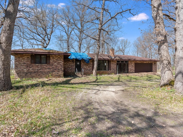 4528 1369th Rd, Earlville, IL 60518 - ranch-style home with brick siding, a chimney, an attached garage, and entry steps