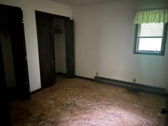 4528 1369th Rd, Earlville, IL 60518 - unfurnished bedroom featuring a baseboard radiator, a closet, and baseboards