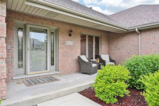 22178 Chamomile Dr, Frankfort, IL 60423 - view of exterior entry featuring a shingled roof, covered porch, and brick siding