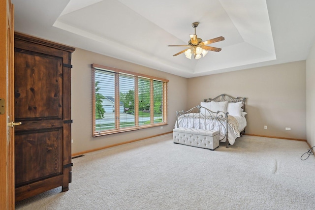22178 Chamomile Dr, Frankfort, IL 60423 - carpeted bedroom with a tray ceiling, baseboards, and a ceiling fan