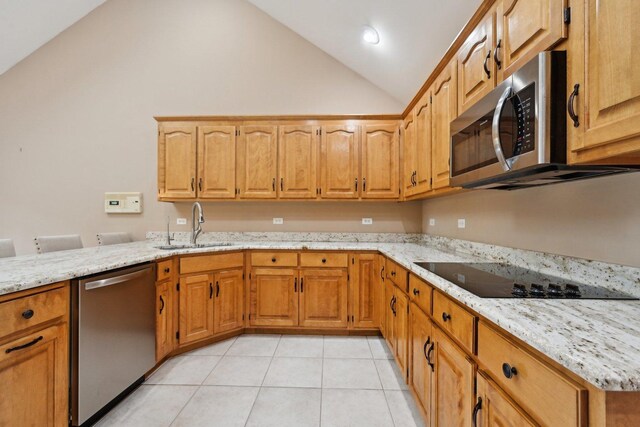 22178 Chamomile Dr, Frankfort, IL 60423 - kitchen with stainless steel appliances, a sink, light tile patterned floors, light stone counters, and brown cabinetry