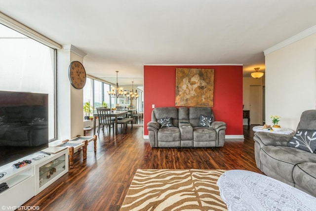 living area featuring a chandelier, wood finished floors, and ornamental molding