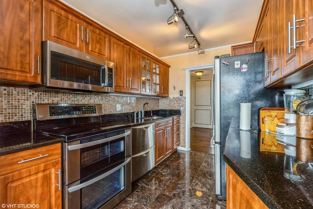 kitchen featuring stainless steel appliances, dark marble finish floors, glass insert cabinets, dark stone countertops, and brown cabinets