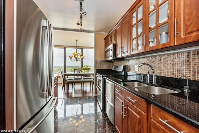 kitchen with stainless steel appliances, a sink, and brown cabinets