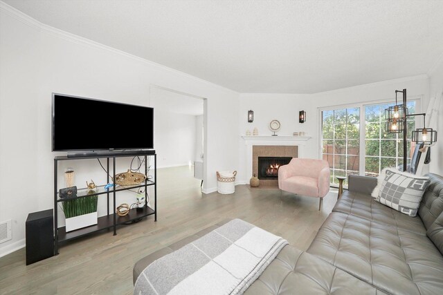 2569 Essex Dr, Northbrook, IL 60062 - living area featuring wood finished floors, crown molding, a lit fireplace, and baseboards