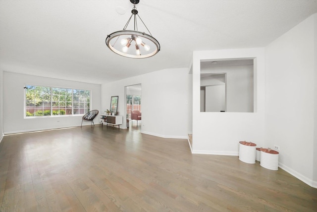 2569 Essex Dr, Northbrook, IL 60062 - empty room with a chandelier, wood finished floors, and baseboards