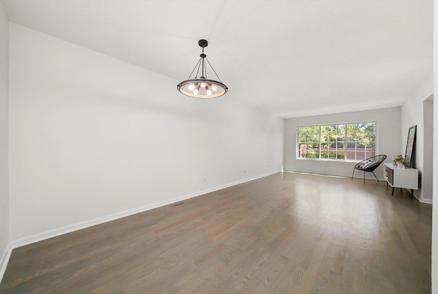 2569 Essex Dr, Northbrook, IL 60062 - unfurnished room with wood finished floors, baseboards, and a chandelier