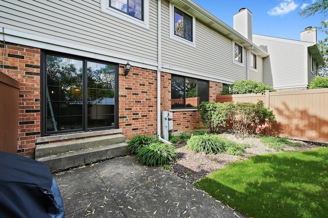 2569 Essex Dr, Northbrook, IL 60062 - doorway to property with brick siding and a chimney