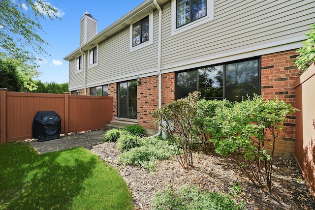 2569 Essex Dr, Northbrook, IL 60062 - back of property with a chimney and brick siding