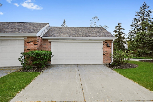 2569 Essex Dr, Northbrook, IL 60062 - view of front of property featuring brick siding, concrete driveway, a shingled roof, and an attached garage