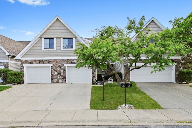 2569 Essex Dr, Northbrook, IL 60062 - view of front of property featuring stone siding, concrete driveway, a garage, and a front lawn
