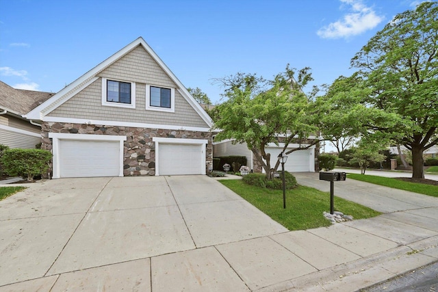 2569 Essex Dr, Northbrook, IL 60062 - view of front facade featuring stone siding and driveway