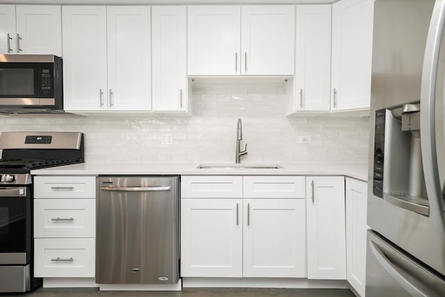 2569 Essex Dr, Northbrook, IL 60062 - kitchen with stainless steel appliances, a sink, white cabinetry, and light countertops