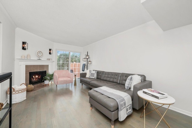 2569 Essex Dr, Northbrook, IL 60062 - living area with wood finished floors, a tile fireplace, ornamental molding, and baseboards