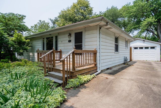 1700 W William St, Champaign, IL 61821 - single story home featuring driveway, an outbuilding, a detached garage, and a deck