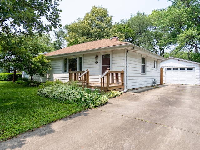 1700 W William St, Champaign, IL 61821 - single story home with an outbuilding, concrete driveway, a chimney, a detached garage, and a front yard