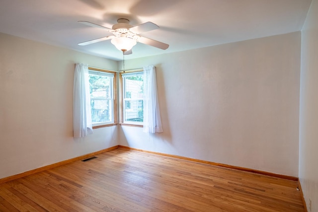 1700 W William St, Champaign, IL 61821 - spare room featuring wood finished floors and a ceiling fan