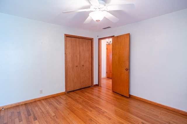 1700 W William St, Champaign, IL 61821 - unfurnished bedroom featuring light wood-style flooring, a closet, and a ceiling fan