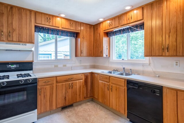 1700 W William St, Champaign, IL 61821 - kitchen featuring black dishwasher, range with gas cooktop, under cabinet range hood, light countertops, and recessed lighting