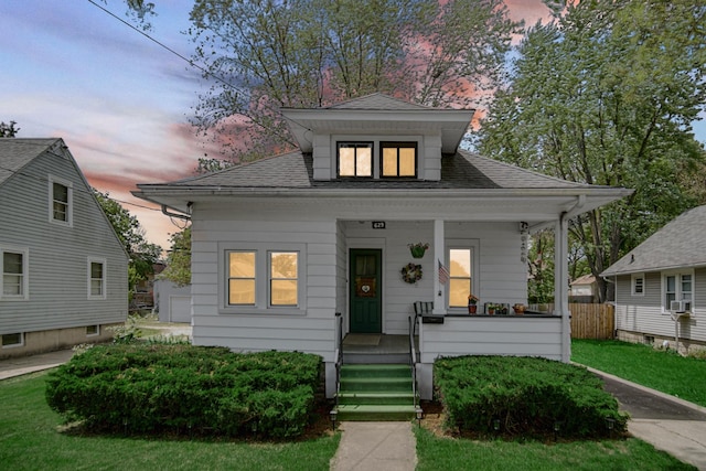 629 S Union St, Aurora, IL 60505 - bungalow-style house featuring a porch, roof with shingles, and cooling unit