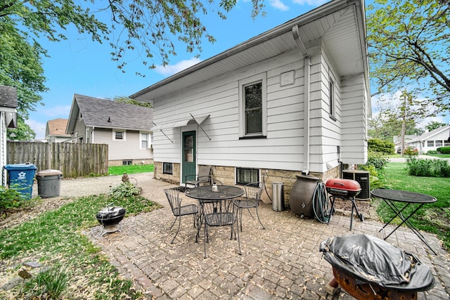 629 S Union St, Aurora, IL 60505 - rear view of house with a patio area, a fire pit, and outdoor dining space