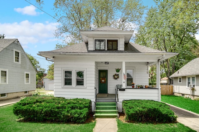 629 S Union St, Aurora, IL 60505 - bungalow with covered porch, roof with shingles, and cooling unit