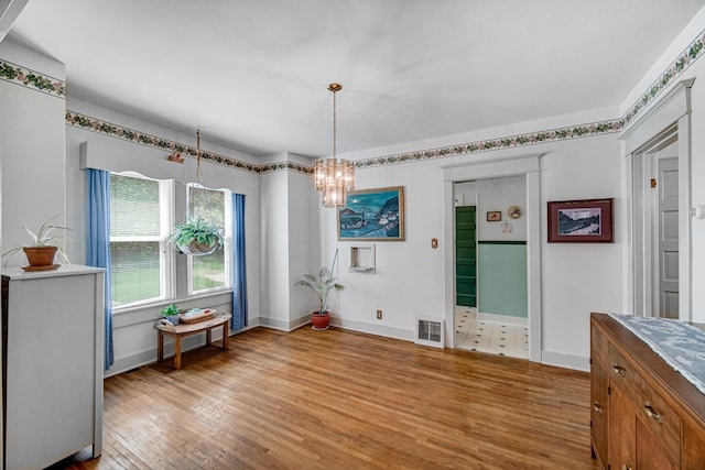 629 S Union St, Aurora, IL 60505 - dining area with light wood-style floors, a chandelier, and baseboards