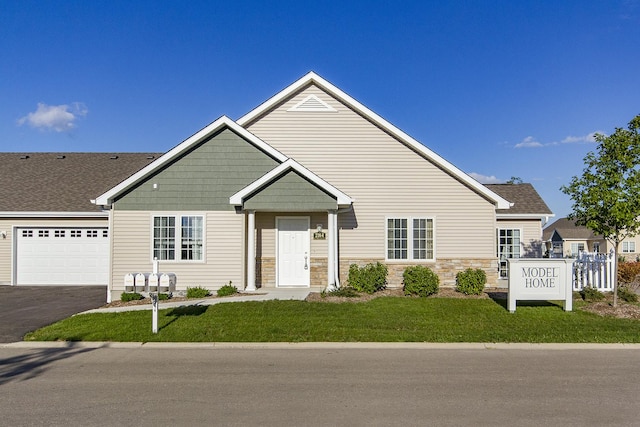 2164 Waterbury Ln W Unit 2164, Sycamore, IL 60178 - view of front of house with a garage, a front yard, driveway, and stone siding