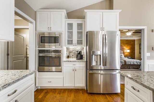 2164 Waterbury Ln W Unit 2164, Sycamore, IL 60178 - kitchen featuring appliances with stainless steel finishes, white cabinetry, glass insert cabinets, dark wood-style floors, and vaulted ceiling