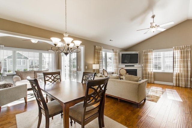 2164 Waterbury Ln W Unit 2164, Sycamore, IL 60178 - dining area with ceiling fan, vaulted ceiling, a fireplace, wood finished floors, and a chandelier