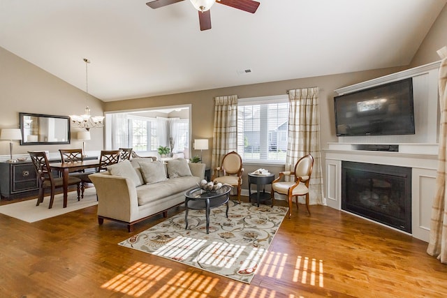 2164 Waterbury Ln W Unit 2164, Sycamore, IL 60178 - living area featuring lofted ceiling, wood finished floors, a chandelier, a glass covered fireplace, and ceiling fan