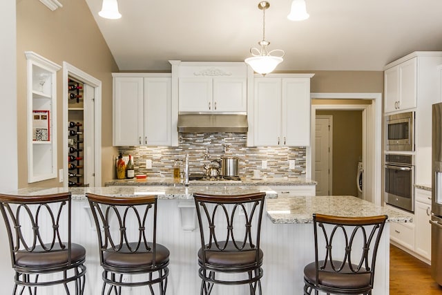 2164 Waterbury Ln W Unit 2164, Sycamore, IL 60178 - kitchen featuring stainless steel appliances, under cabinet range hood, tasteful backsplash, white cabinets, and light stone countertops