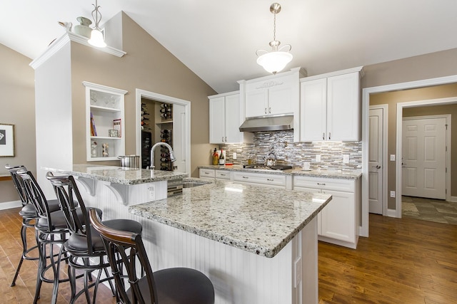 2164 Waterbury Ln W Unit 2164, Sycamore, IL 60178 - kitchen with a sink, under cabinet range hood, lofted ceiling, stainless steel gas stovetop, and white cabinets