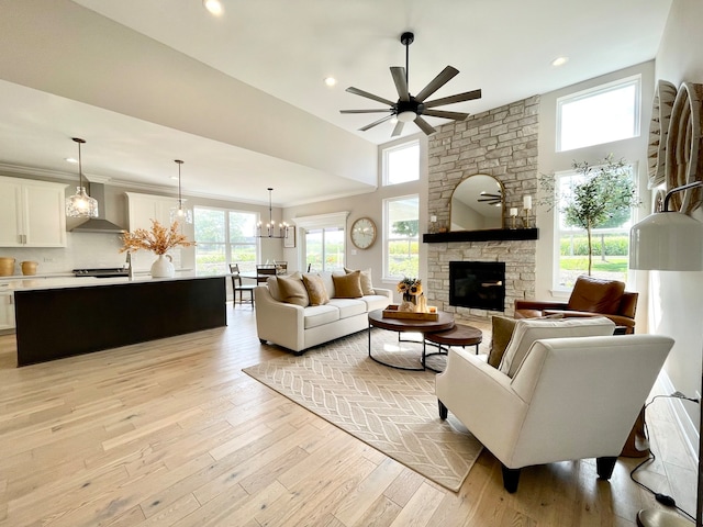 LOTT315929 Prairie View Ct, New Lenox, IL 60451 - living room with a ceiling fan, a fireplace, light wood-style floors, recessed lighting, and a chandelier