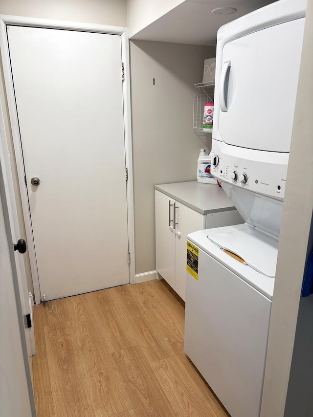 1487 Kathleen Way, Elk Grove Village, IL 60007 - laundry area with stacked washer / drying machine, cabinet space, and light wood-style floors