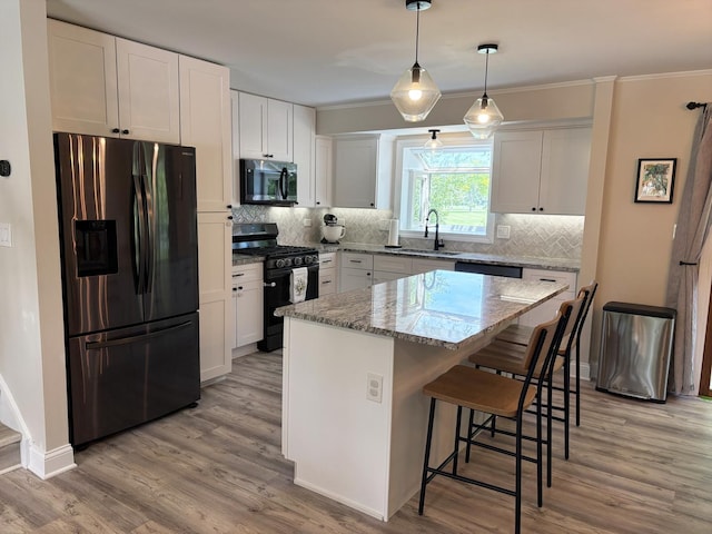 1487 Kathleen Way, Elk Grove Village, IL 60007 - kitchen with stainless steel fridge with ice dispenser, black range with gas cooktop, light wood-style floors, white cabinets, and ornamental molding