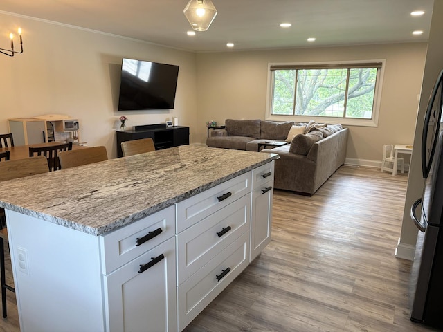 1487 Kathleen Way, Elk Grove Village, IL 60007 - kitchen with a kitchen bar, white cabinets, recessed lighting, light stone countertops, and a center island