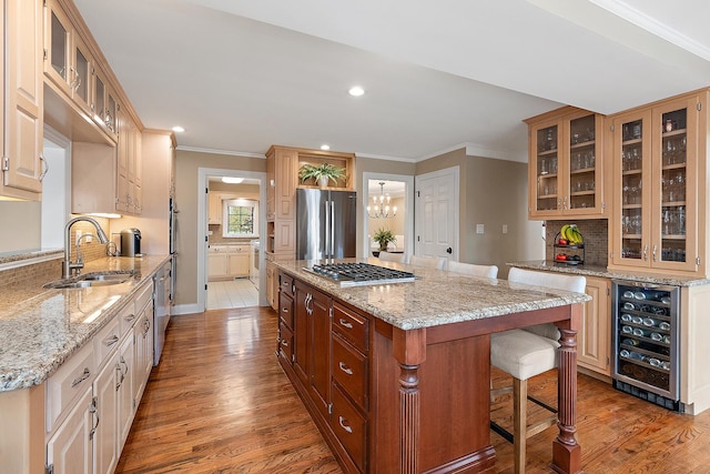 12000 W Donegal Ln, New Lenox, IL 60451 - kitchen featuring wine cooler, appliances with stainless steel finishes, a kitchen island, wood finished floors, and ornamental molding