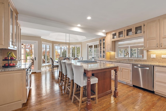12000 W Donegal Ln, New Lenox, IL 60451 - kitchen with stainless steel dishwasher, a kitchen bar, backsplash, light wood finished floors, and recessed lighting