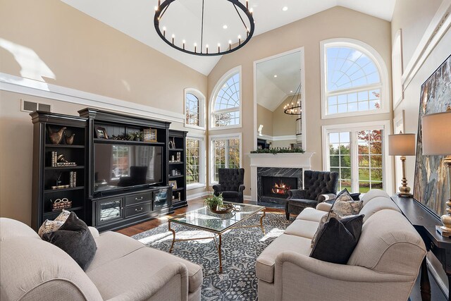 12000 W Donegal Ln, New Lenox, IL 60451 - living room with a chandelier, high vaulted ceiling, wood finished floors, a high end fireplace, and recessed lighting