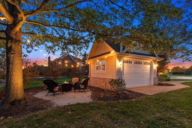 12000 W Donegal Ln, New Lenox, IL 60451 - garage at dusk featuring a yard